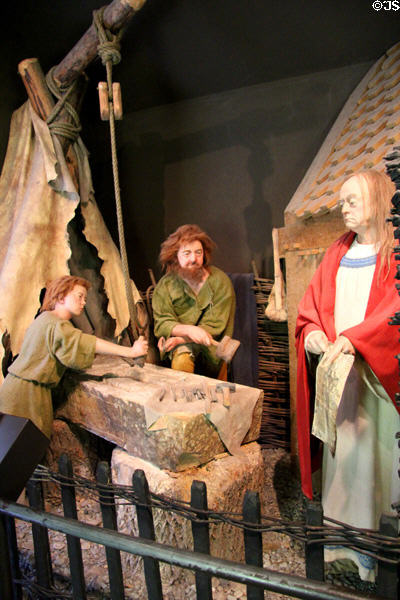 Display depicting stone carvers at Clonmacnoise museum. Ireland.