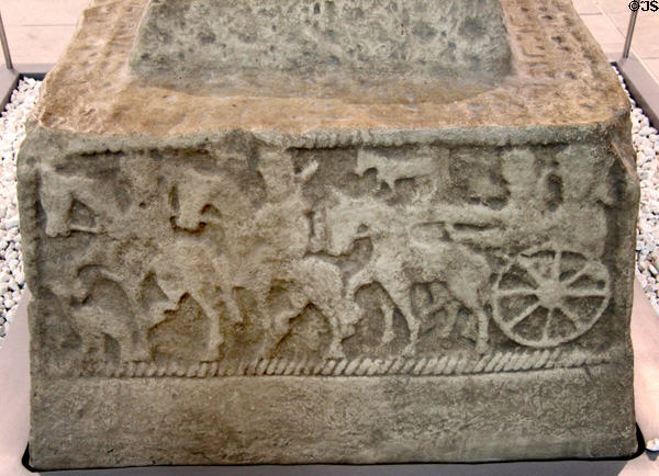 Chariot procession scene (800s) on plaster replica of north high cross from Ahenny in County Tipperary at Medieval Mile Museum. Kilkenny, Ireland.