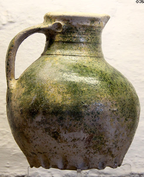 Medieval pottery jug (c1250-1350) with frill base to steady it at Rothe House. Kilkenny, Ireland.
