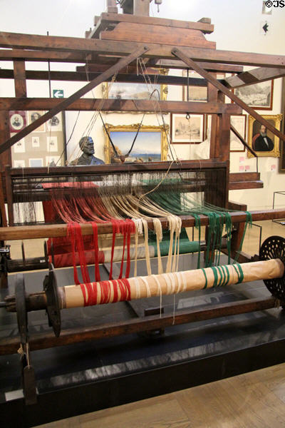 Loom weaving Italian tricolor flag, symbolically completing 1849-59 transformation from regional states to nation at Risorgimento Museum. Turin, Italy.