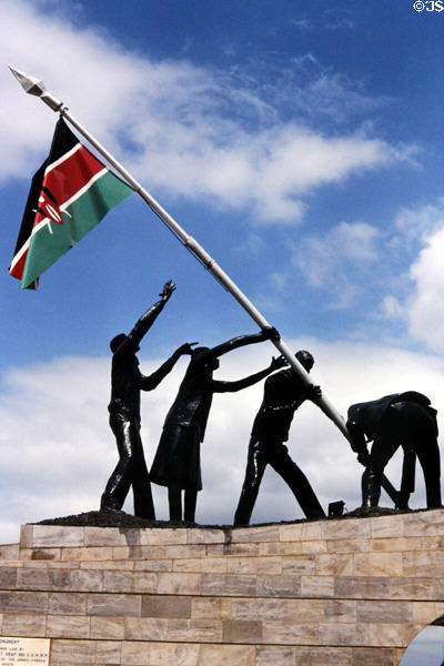 Figures raising Kenyan flag part of Uhuru Monument near Nairobi. Kenya.