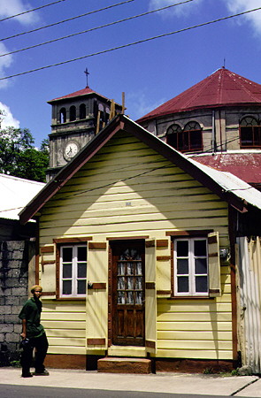 Yellow house in Castries old town with Cathedral in background. St Lucia.