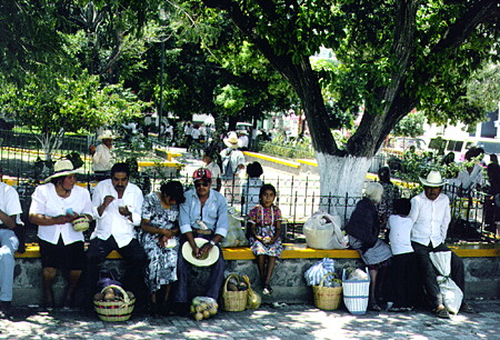 Market visitors resting on benches in Acatlán. Mexico.