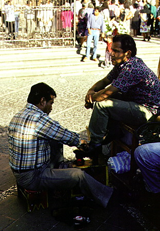 Shoeshine service on streets of Taxco. Mexico.