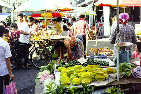 Market in Kuching, Sarawak with starfruit in foreground. Malaysia.