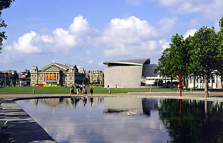 Museum Plein pool with Concertgebouw (concert hall) & modern Van Gogh Museum. Amsterdam, Netherlands.