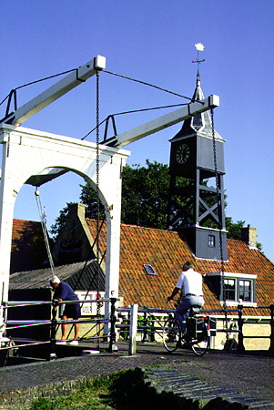 Bicyclist crosses a lift bridge. Hindeloopen, Netherlands.