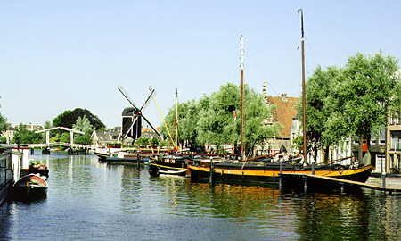 View of windmill & barges on Rijn Galgewater. Leyden, Netherlands.