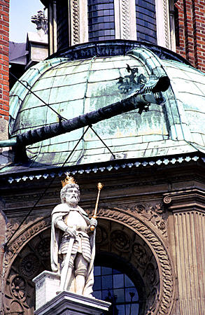 Statue with gold scepter & crown in front if Wawal Cathedral, Krakow. Poland.