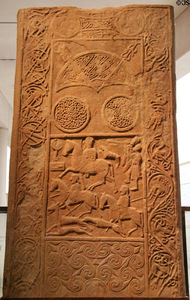 Pictish stone inscribed with aristocratic woman leading a hunting party plus symbolic crescent, double disks, spirals & entwined animals (800-900) from Hilton of Cadboll at National Museum of Scotland. Edinburgh, Scotland.