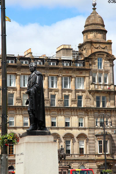 Merchants' House with tower (1878) by John Burnet (on George Square) beyond statue of poet Thomas Campbell. Glasgow, Scotland.