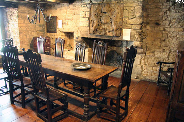 Scottish oak table & chairs (17thC) before fireplace with carved royal coat of arms of Charles II (c1660-85) at Provand's Lordship. Glasgow, Scotland.