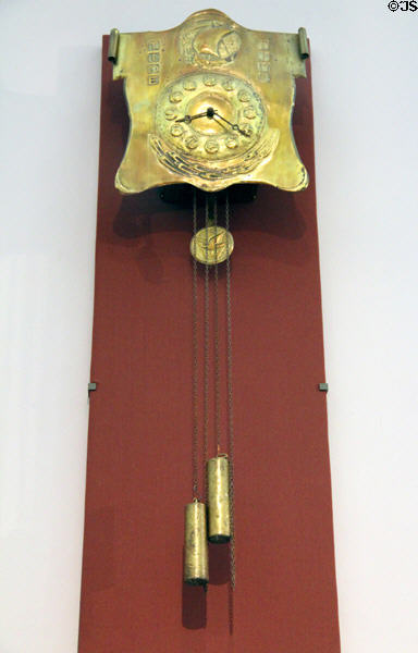 Brass wall clock (1900) by Peter Wylie Davidson of Glasgow at Kelvingrove Art Gallery. Glasgow, Scotland.