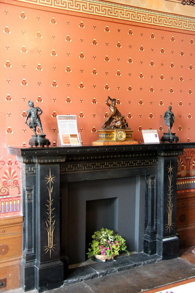 Incised & gilded black marble fireplace with classical clock & statues on mantle in dining room at Holmwood. Glasgow, Scotland.