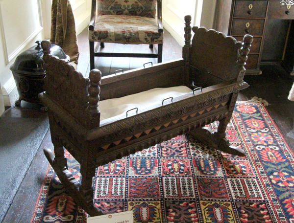 King's room with cradle once used by baby King James VI of Scotland (James I of England) at Traquair House. Scotland.