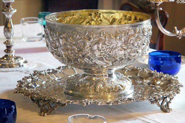 Silver punchbowl with battle scene on stand in dining room at Traquair House. Scotland.