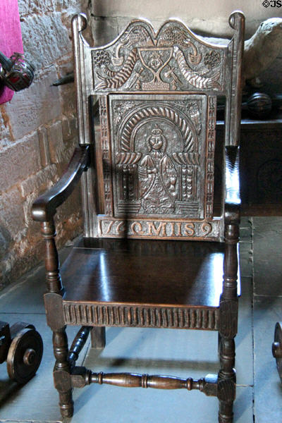 Carved armchair (1689) with image of Queen Mary II in crypt at Glamis Castle. Angus, Scotland.