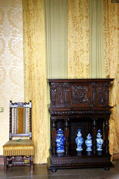 Carved sidechair & cabinet with porcelain Delftware in Keeper's bedroom at Falkland Palace. Falkland, Scotland.