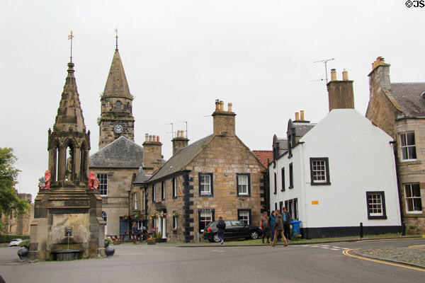 Falkland High Street with Bruce Fountain, Town Hall, 1717 hotel with quoins & Seyton House (1868). Falkland, Scotland.