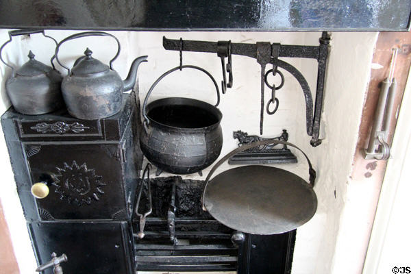 Kitchen fireplace including Scottish bannock bread girdle (griddle) at Robert Burns House. Dumfries, Scotland.