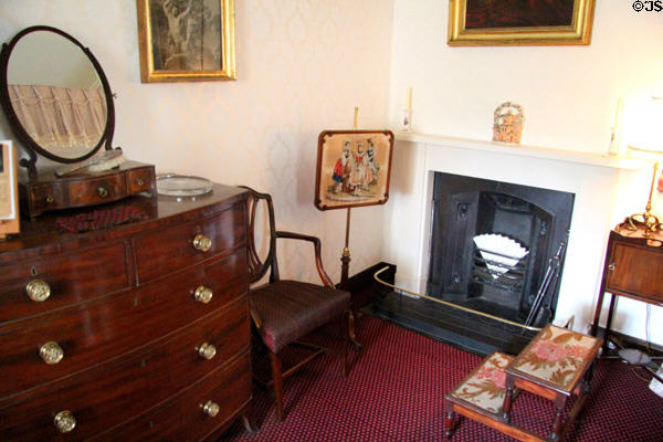 Fireplace, chest of drawers & step stool to climb to bed in Pink Room at Castle Fraser. Aberdeenshire, Scotland.