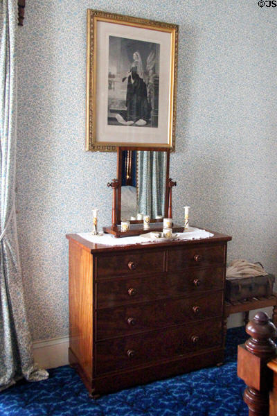 Chest of drawers with tilting mirror under graphic of Queen Victoria in Albert bedroom at Haddo House. Methlick, Scotland.