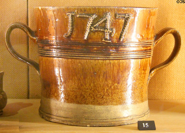 Glazed buff clay loving cup with manganese stain (1747) made in Straffordshire at Potteries Museum & Art Gallery. Hanley, Stoke-on-Trent, England.