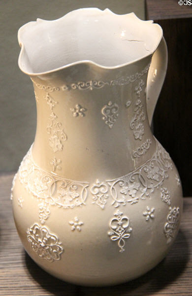 Light brown jug with applied molded white relief decoration (1730-50) by Aaron Wedgwood or his sons Thomas & John (cousins of Josiah) of Burslem, North Straffordshire at Potteries Museum & Art Gallery. Hanley, Stoke-on-Trent, England.