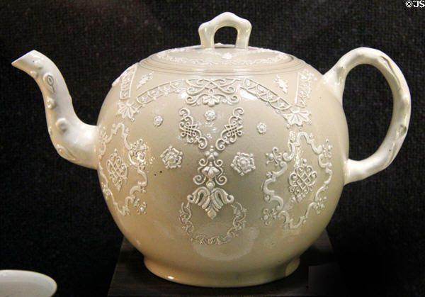 Light brown punch pot with applied molded white relief decoration (1730-50) made in North Straffordshire at Potteries Museum & Art Gallery. Hanley, Stoke-on-Trent, England.