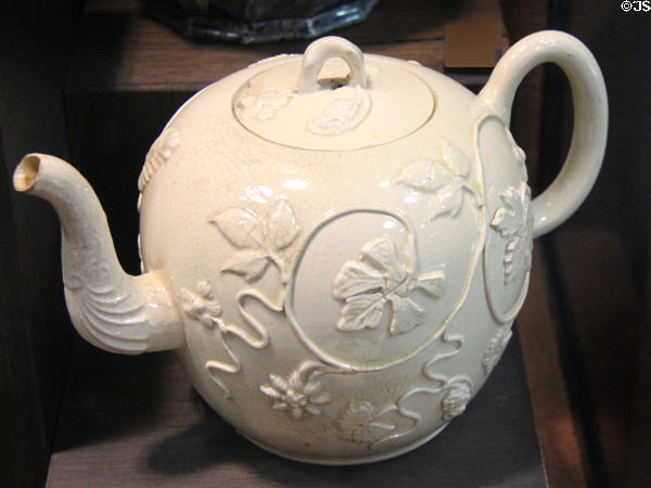 Cream colored earthenware teapot with sprigs (c1760-70) made in Straffordshire at Potteries Museum & Art Gallery. Hanley, Stoke-on-Trent, England.