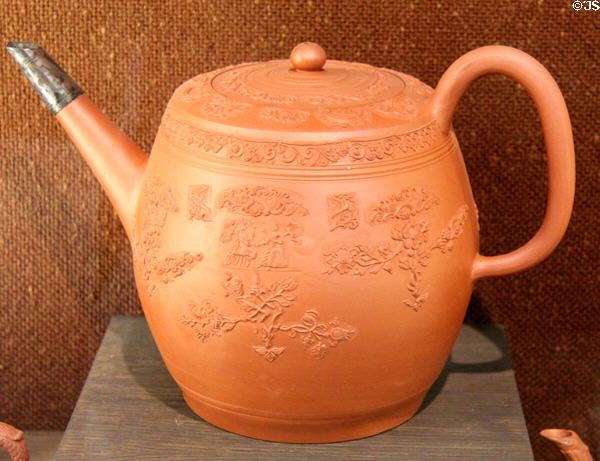 Red earthenware punch pot with relief scene of George III & Queen Charlotte (c1760-5) prob. made in Straffordshire at Potteries Museum & Art Gallery. Hanley, Stoke-on-Trent, England.