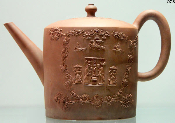 Red stoneware teapot with applied molded relief decoration (c1770) made in Straffordshire at Potteries Museum & Art Gallery. Hanley, Stoke-on-Trent, England.
