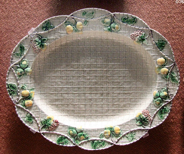 Press molded dish with border showing fruit & nuts (c1760-70) prob. made in Straffordshire at Potteries Museum & Art Gallery. Hanley, Stoke-on-Trent, England.