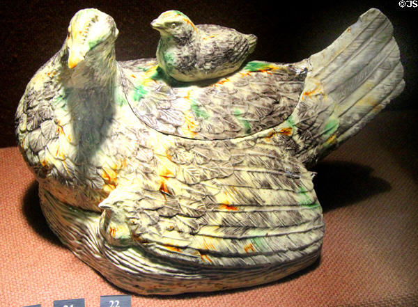 Press molded tureen in form of hen stained with colored oxides under lead glaze (c1760-80) prob. made in Straffordshire at Potteries Museum & Art Gallery. Hanley, Stoke-on-Trent, England.
