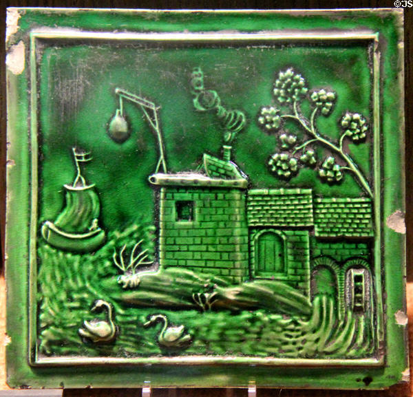Earthenware molded tile with green glaze (c1760-70) probably Thomas Whieldon pot works of Fenton, Straffordshire at Potteries Museum & Art Gallery. Hanley, Stoke-on-Trent, England.