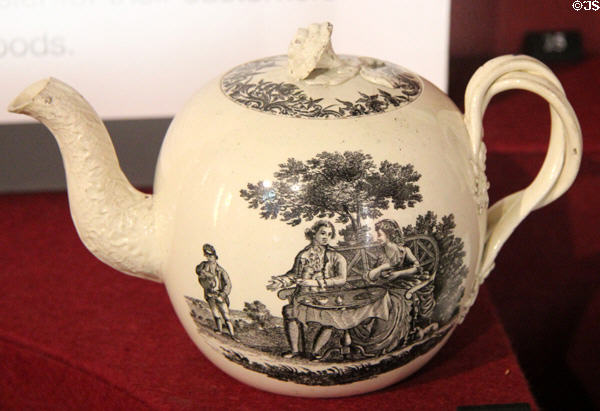 Creamware teapot with transfer printing of couple having tea in garden (1765-1800) attrib. Wedgwood of Burslem or Etruria, Staffordshire at Potteries Museum & Art Gallery. Hanley, Stoke-on-Trent, England.