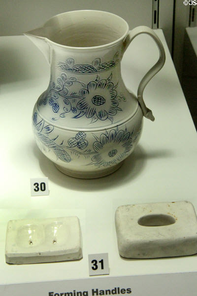 Dies for extruding handles (19thC) & resulting salt-glazed stoneware jug with scratch blue decor bearing example of handle (c1760) made in Staffordshire at Potteries Museum & Art Gallery. Hanley, Stoke-on-Trent, England.