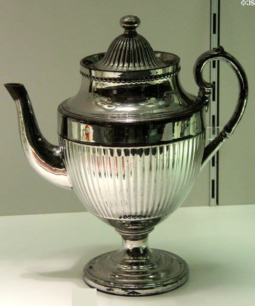Example of silver liquid lustre surface (derived from platinum) on earthenware coffee pot (early 19thC) from Staffordshire at Potteries Museum & Art Gallery. Hanley, Stoke-on-Trent, England.