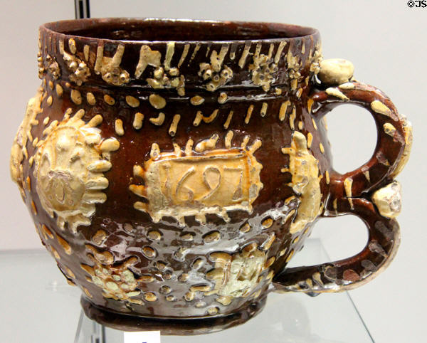Slip decorated posset pot or jug (1697) by Henry Ifield of Wrotham, Kent at Potteries Museum & Art Gallery. Hanley, Stoke-on-Trent, England.