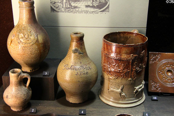 Jugs made in London (c1700) in styles of bottles imported from Germany at Potteries Museum & Art Gallery. Hanley, Stoke-on-Trent, England.