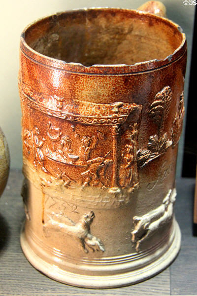Tankard with applied decoration images after Hogarth (1752) by Francis Salt made in Fulham, London at Potteries Museum & Art Gallery. Hanley, Stoke-on-Trent, England.