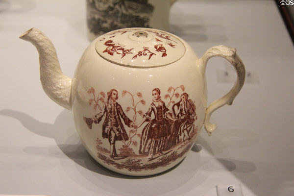 Queen's Ware transfer-printed over glaze teapot with dancing figures beside violin player (c1770) by Wedgwood at World of Wedgwood. Barlaston, Stoke, England.