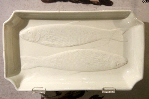 Queen's Ware herring disk with two molded fish (1780-2) by Wedgwood for export to Holland at World of Wedgwood. Barlaston, Stoke, England.