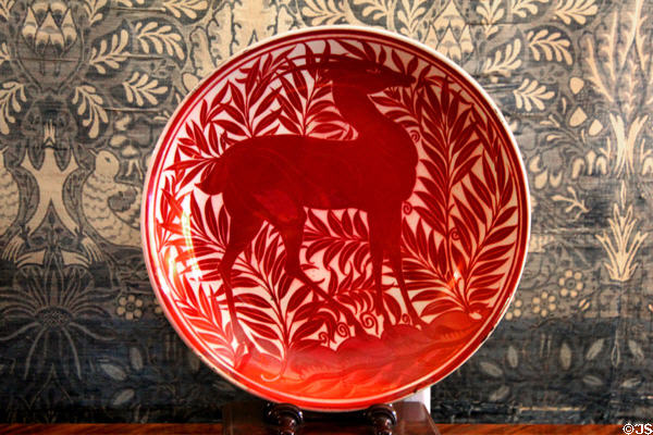 Ruby lustre plate with antelope inspired by medieval Islamic design (19thC) by William De Morgan at Wightwick Manor. Wolverhampton, England.