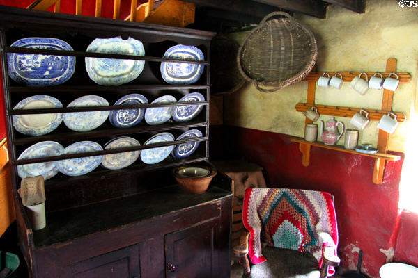 Kitchen sideboard with porcelain plates in Coshkib Hill Farm at Ulster Folk Park. Belfast, Northern Ireland.