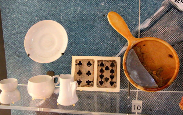 Vessels, playing cards & mirror salvaged from wreck of Titanic at Ulster Transport Museum. Belfast, Northern Ireland.