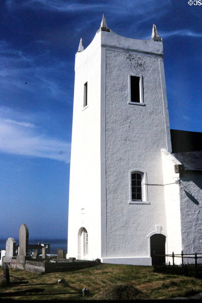 White tower of simple church at Ballintoy Harbour. Northern Ireland.