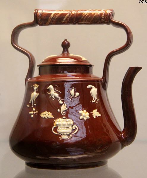 Red & white earthenware tea kettle with molded decoration (c1745) made in Staffordshire at British Museum. London, United Kingdom.