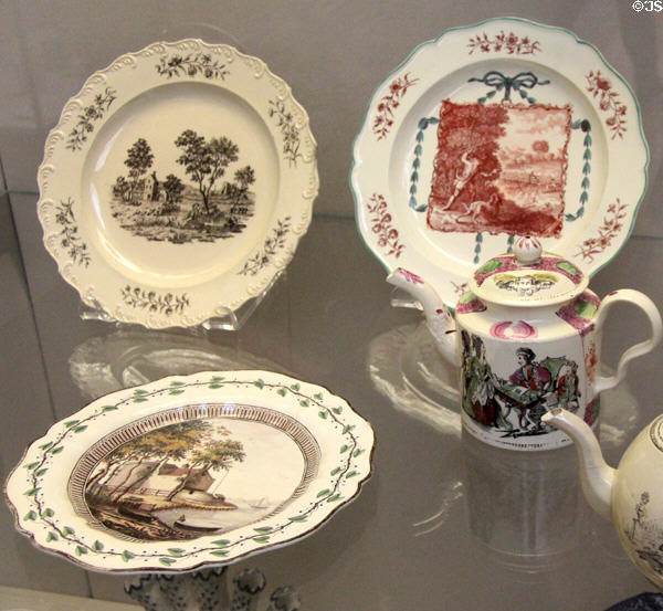 Transfer printed creamware plates (c1770-5) by Wedgwood plus teapots not by Wedgwood from Staffordshire at British Museum. London, United Kingdom.