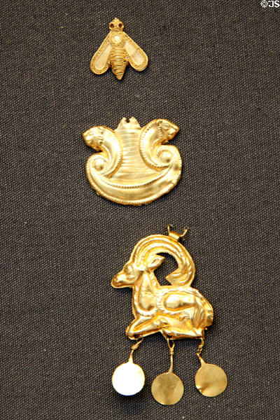 Three Minoan sheet gold ornaments showing bee, lions, goat (1700-1550 BCE) from Crete at British Museum. London, United Kingdom.
